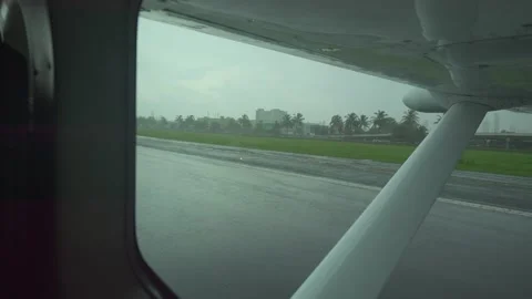 Rain falls on the runway through the window Stock Footage 345419767
