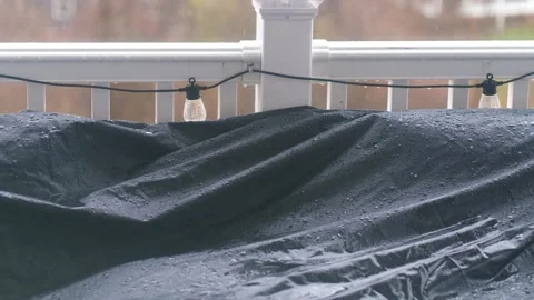 Rain falls softly on a suburban balcony covered with a tarp during a cloudy day. Stock Footage 302117656