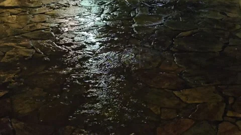 Rain falls on the stone floor at night (another angle) Video stock 271392659