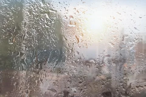 Rain falls on the window with a blurred background. Indicates a rainy day Stock Photos
