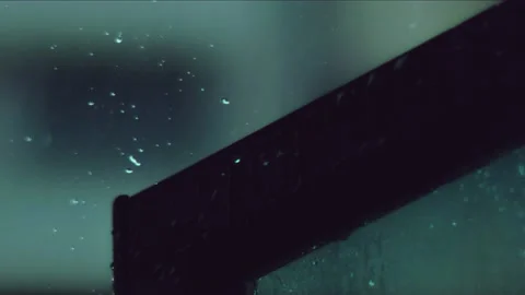 RAIN FALLS ON WINDOW PANEL SLOW MOTION Video stock 236280547