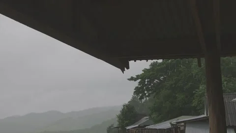 Rain flowing down from the eaves of the hut. Stock Footage 282897702