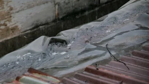 The rain flows down the gutter of the roof of the house Stock Footage 290283561