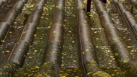Rain flows down on a roof Stock Footage 242999267