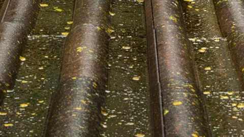 Rain flows down on a roof Stock Footage 242999276