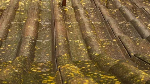 Rain flows down on a roof Stock Footage 242999324