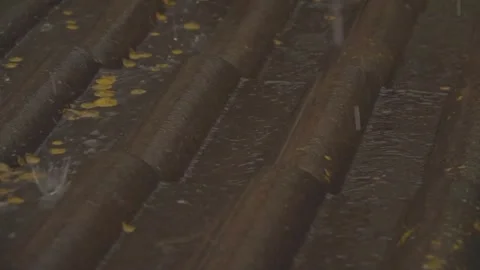 Rain flows down on a roof Stock Footage 245478399
