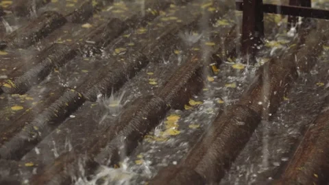 Rain flows down on a roof Stock Footage 245478491