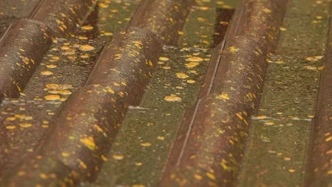 Rain flows down on a roof Stock Footage 248301087