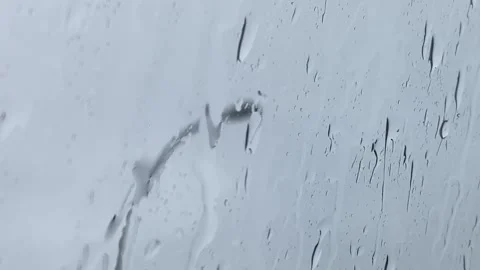 Rain in Focus with Light Pole Blurry from Car Window POV Stock Footage 302707519