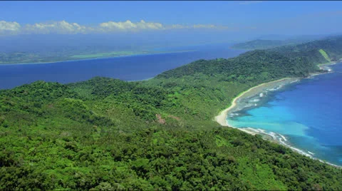Rain forest covered peninsular with white sand beach Stock Footage 25354477