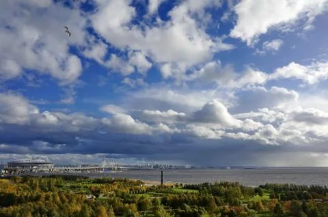 The rain front is approaching the city. In the frame is a park, river, bridge Stock Photos