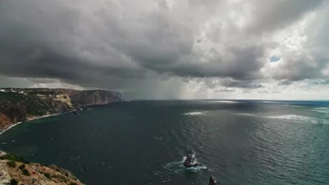 A rain front moving across the sea bay, the coast before the storm. Long shot Stock Footage 218405023