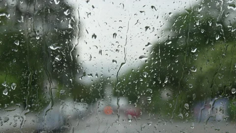 Rain on glass of a bus or car. Raindrops run down the window. Background of a Stock Footage 207907019