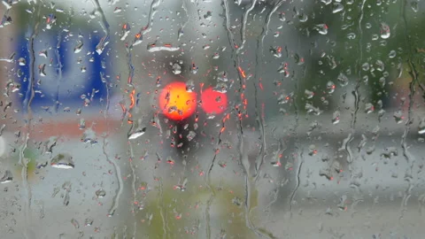 Rain on glass of a bus or car. Raindrops run down the window. Background of a Stock Footage 207921978