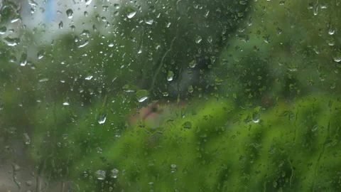 Rain on glass of a bus or car. Raindrops run down the window. Background of a Stock Footage 207923645
