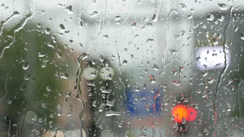 Rain on glass of a bus or car. Raindrops run down the window. Background of a Stock Footage 207931956