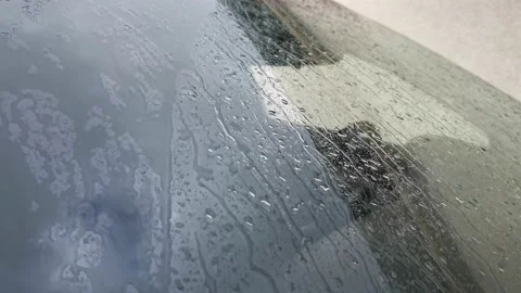 Rain glass car. Drops of close-up flow down the windshield of a standing car Stock Footage 166266013
