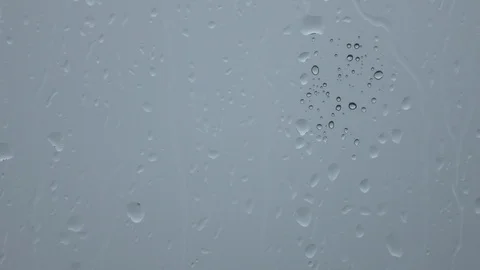 Rain gray sky behind wet glass. Water drops on window. Video stock 100238677