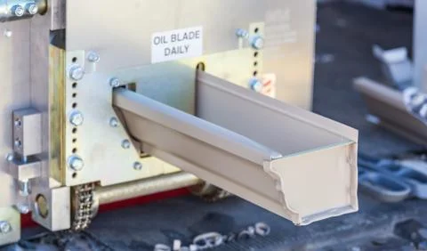 Rain Gutter Feeding Through Seamless Shaping Machine Stock Photos