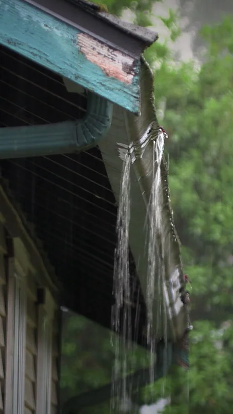 Rain gutter overflowing low angle vertical Stock Footage 345851883