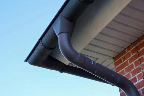 Rain gutter system collecting water on residential building Stock Photos