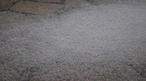 Rain with hail falling on the tailed sidewalk. Stock Photos