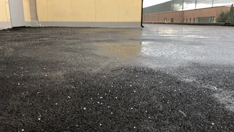 Rain hailstorm start falling on the asphalt. All season hailstorm Stock Footage 125405132
