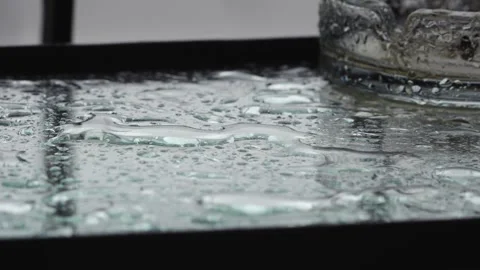 Rain Hitting Glass Table and Ashtray (Extreme Close-up) Stock Footage 241021114