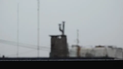 Rain Hitting Handrail With Chimneys as Background 1 Stock Footage 241021117