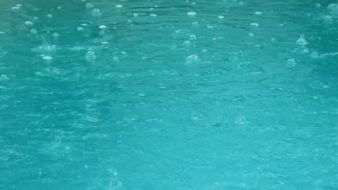 Rain hitting a pool of water Stock Footage 91494949