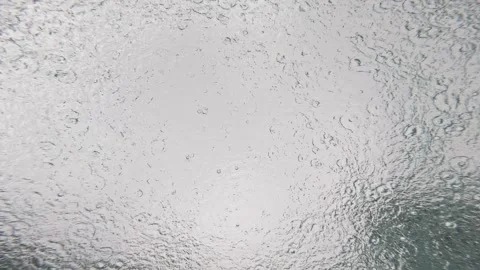 Rain Hitting the Sea Surface Viewed from Underwater with Bubbles and Ripples Stock Footage 341379240