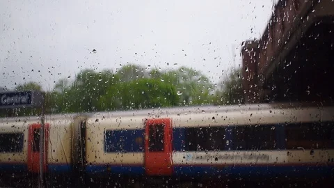Rain hitting a window at a train station Stock Footage 108643516