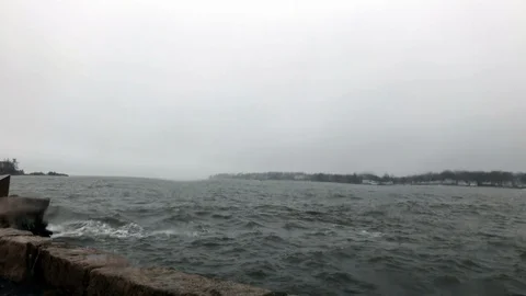 Rain hitting windshield with stormy ocean in background wave crash Stock Footage 100608839