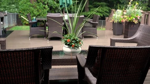 Rain lightly pattering on a suburban deck during a summer storm with a Stock Footage 118599553