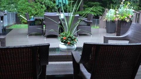 Rain lightly pattering on a suburban deck during a summer storm with a Stock Footage 118599718