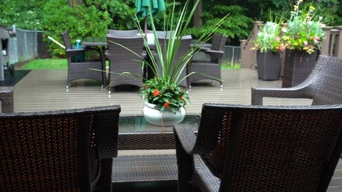 Rain lightly pattering on a suburban deck during a summer storm with Stock Footage 118599733