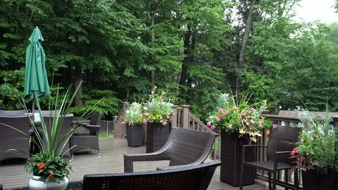 Rain lightly pattering on a suburban deck during a summer storm. Filmed in Stock Footage 118599747