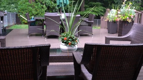 Rain lightly pattering on a suburban deck during a summer storm with a Stock Footage 118600146