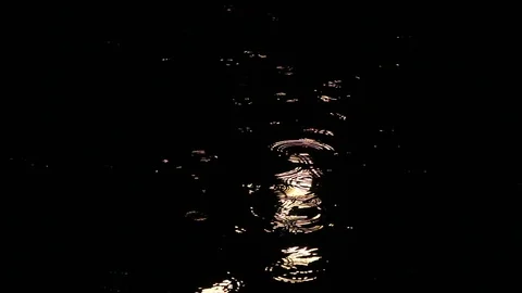 Rain at night drips through the puddles. circles on the water from the drops Stock Footage 112221804