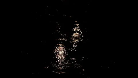 Rain at night drips through the puddles. circles on the water from the drops Stock Footage 112221853