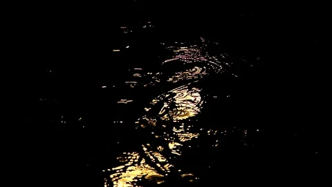 Rain at night drips through the puddles. circles on the water from the drops Stock Footage 112222129