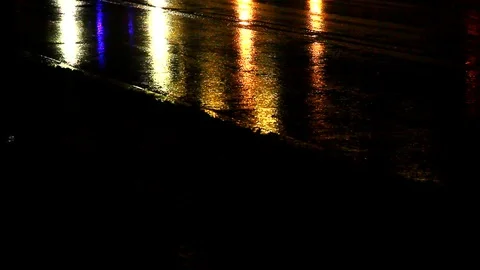 Rain at night drips through the puddles on the pavement against the backdrop Stock Footage 112222279