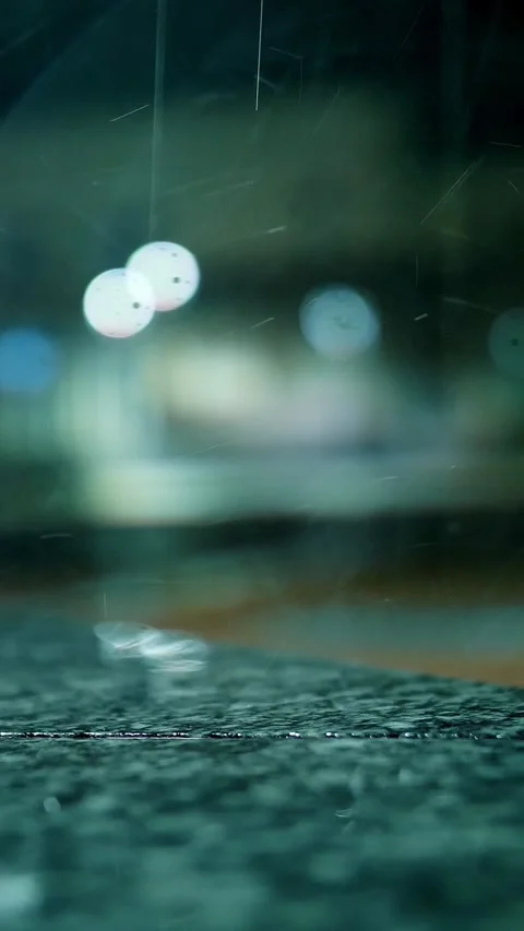 Rain in the night. Puddle. Streetlight. Rain drops Falling On puddle. Close-up. Stock Footage 317167016