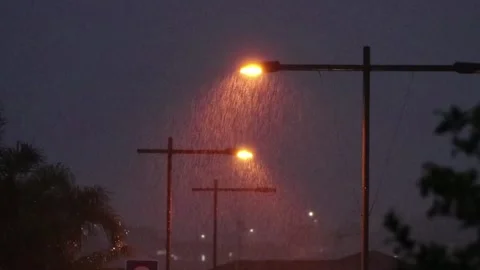 Rain at night on street lights Stock Footage 243372680