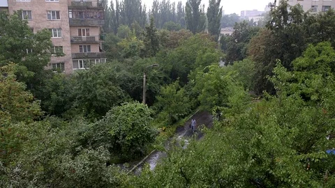 Rain with old soviet apartment flat buildings in Rivne, Ukraine, man walking Stock Footage 97682370