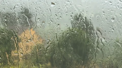 Rain outside the window seen through window pane with raindrops Stock Footage 249010889