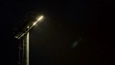 Rain over Stadium Lights Stockbeeldmateriaal 218404653