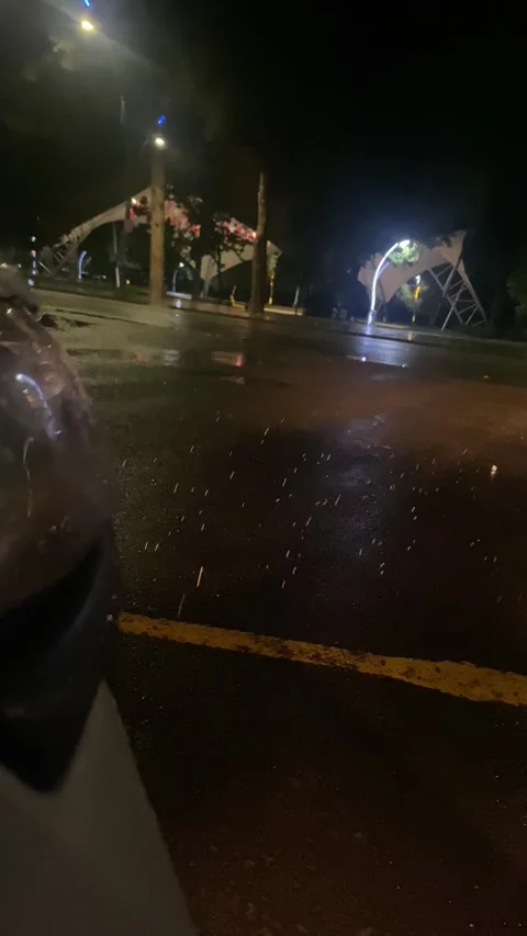 Rain Particles in Headlights on Wet Road at Night Stock Footage 347747792