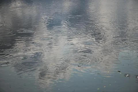 Rain Patterns Reflecting Cloudy Sky On Water Stock Photos